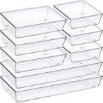 An 8-pack set of clear acrylic drawer organizers with non-slip pads, shown neatly arranged in a drawer, holding various small