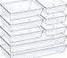 An 8-pack set of clear acrylic drawer organizers with non-slip pads, shown neatly arranged in a drawer, holding various small