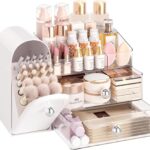 A white Delamu large makeup organizer with clear drawers and a retro fridge-style top compartment holding makeup brushes and 