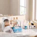 A white Delamu large makeup organizer with clear drawers and a retro fridge-style top compartment holding makeup brushes and