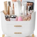 White HALAFE makeup organizer with two drawers and a top compartment, featuring gold accents and a ribbed texture.