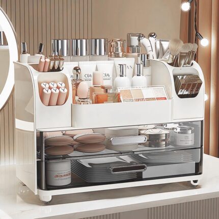 Heaime white acrylic makeup organizer with two drawers and an open top section holding brushes, lipsticks, and skincare bottl