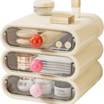 MavHubrix 3-Tier Cream White Makeup Organizer with colorful knobs on a vanity, holding cosmetics and small items.
