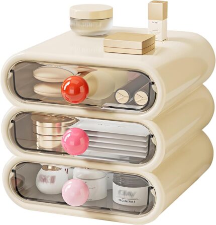 MavHubrix 3-Tier Cream White Makeup Organizer with colorful knobs on a vanity, holding cosmetics and small items.