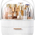 A white and gold NestOrganix makeup organizer with three drawers and a clear top cover, filled with various cosmetics.