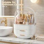 A white and gold NestOrganix makeup organizer with three drawers and a clear top cover, filled with various cosmetics.
