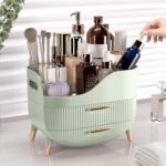 Pajiriona sage green makeup organizer with two drawers and a top compartment, featuring a handle, displayed on a vanity.