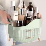 Pajiriona sage green makeup organizer with two drawers and a top compartment, featuring a handle, displayed on a vanity.