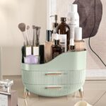 Pajiriona sage green makeup organizer with two drawers and a top compartment, featuring a handle, displayed on a vanity.
