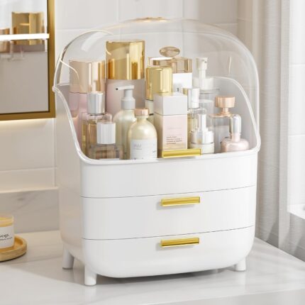 White Vtopmart 3-Tier Skincare Organizer with clear lid, two drawers, and gold handles, filled with beauty products.