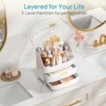 White Vtopmart 3-Tier Skincare Organizer with clear lid, two drawers, and gold handles, filled with beauty products.