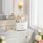 White Vtopmart 3-Tier Skincare Organizer with clear lid, two drawers, and gold handles, filled with beauty products.