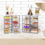 Four clear acrylic makeup organizers stacked and side-by-side, showcasing multiple drawers filled with various cosmetics and