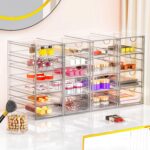 Four clear acrylic makeup organizers stacked and side-by-side, showcasing multiple drawers filled with various cosmetics and