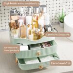 Green YGJT makeup organizer with two drawers and a top compartment, featuring a golden handle and filled with various cosmeti