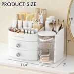 White countertop makeup organizer with two drawers and an open top compartment, filled with various cosmetic products.